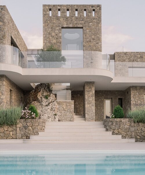 wrapped in stone and rooted by an olive tree, corfu house overlooks the sea in greece
